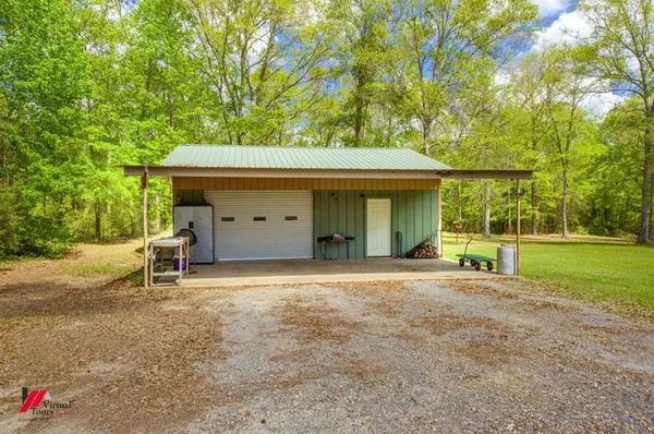 a view of a house with a backyard and a tree