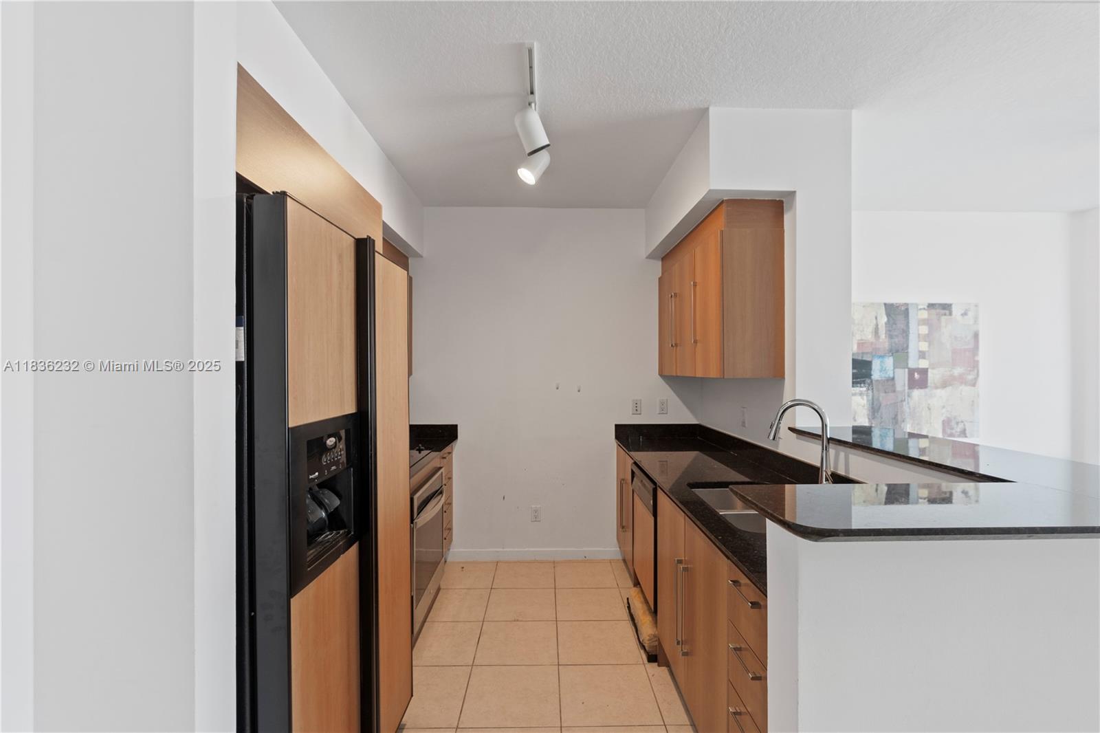 335 South Biscayne Boulevard, Unit 3410 Miami, FL 33131 - Photo 13 of 51 a kitchen with stainless steel appliances granite countertop a sink and a stove top oven
