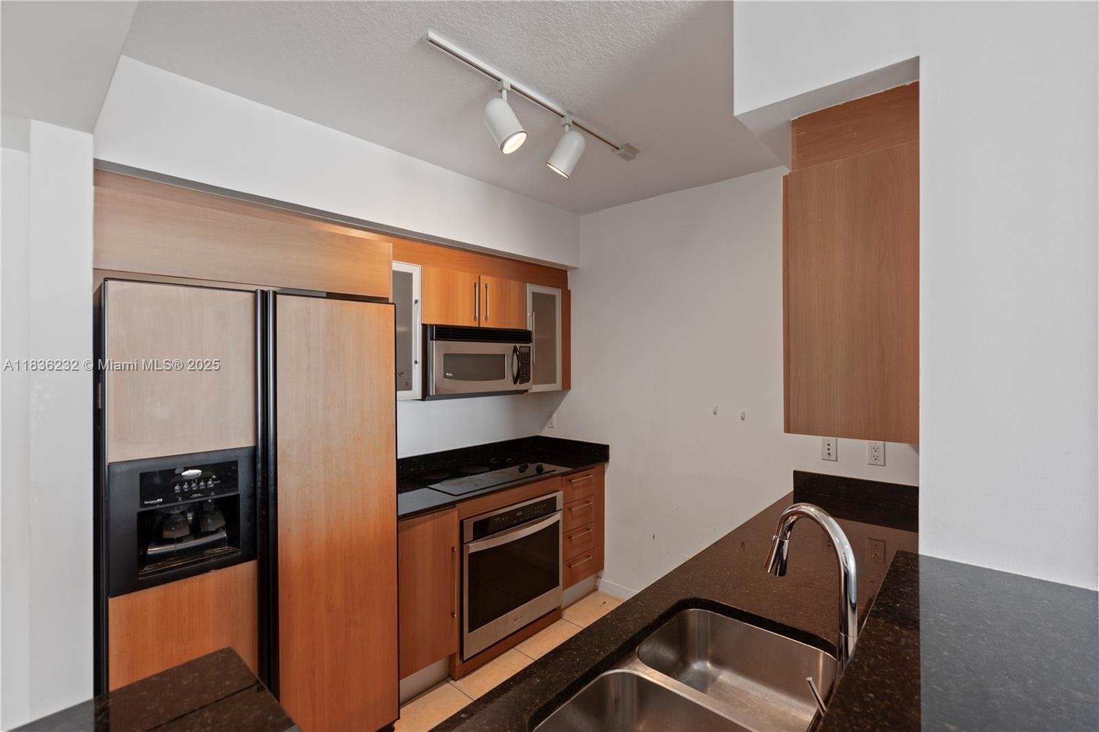 335 South Biscayne Boulevard, Unit 3410 Miami, FL 33131 - Photo 15 of 51 a kitchen with stainless steel appliances granite countertop a refrigerator and a stove top oven