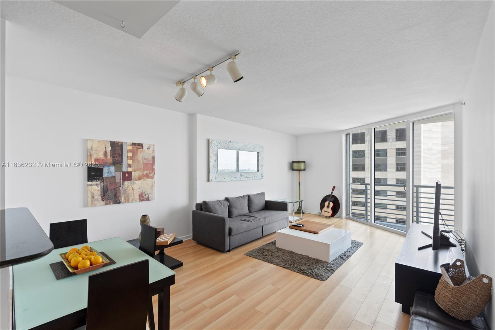 335 South Biscayne Boulevard, Unit 3410 Miami, FL 33131 - Photo 16 of 51 a living room with furniture and windows