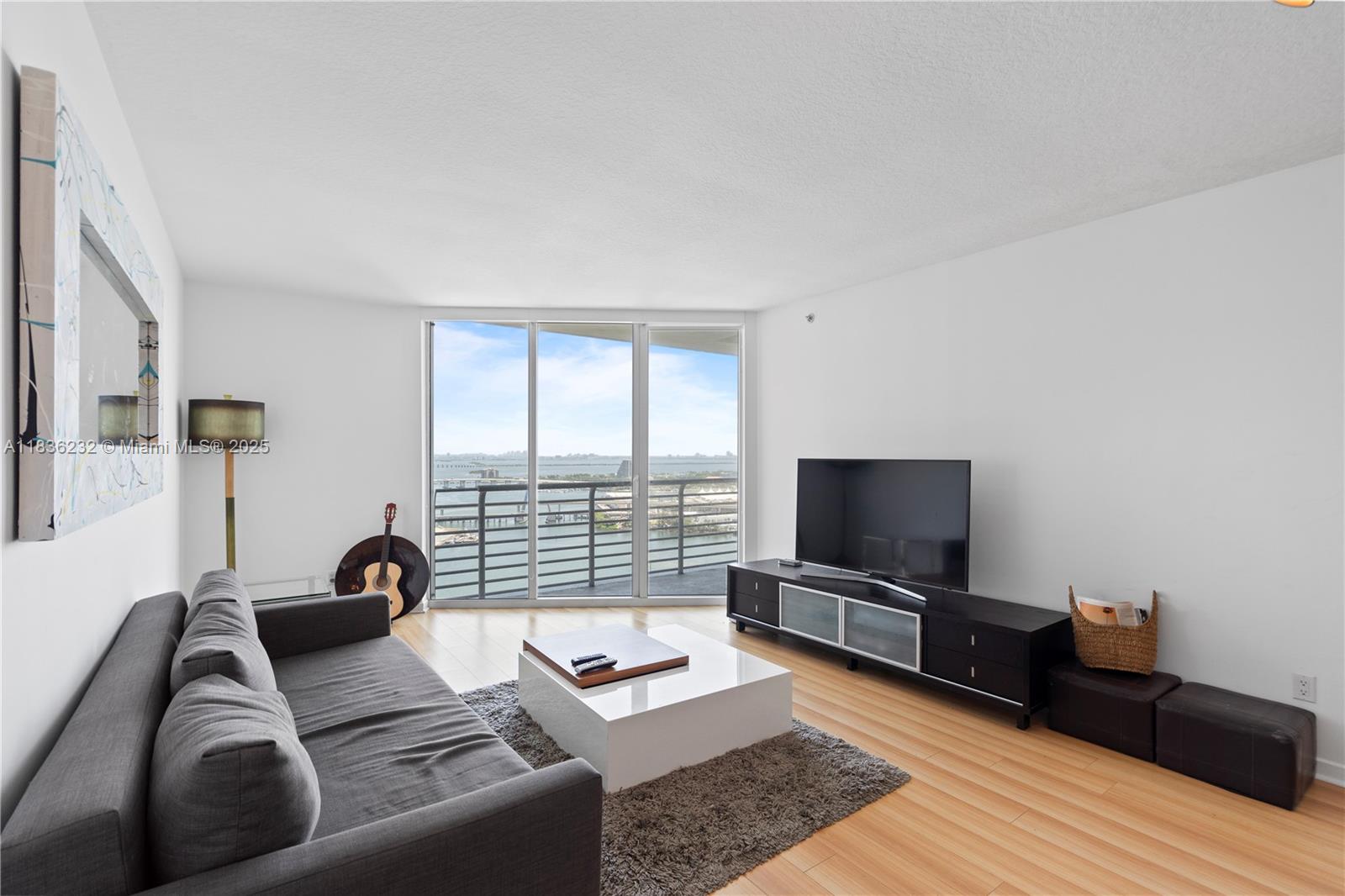 335 South Biscayne Boulevard, Unit 3410 Miami, FL 33131 - Photo 18 of 51 a living room with furniture and a flat screen tv
