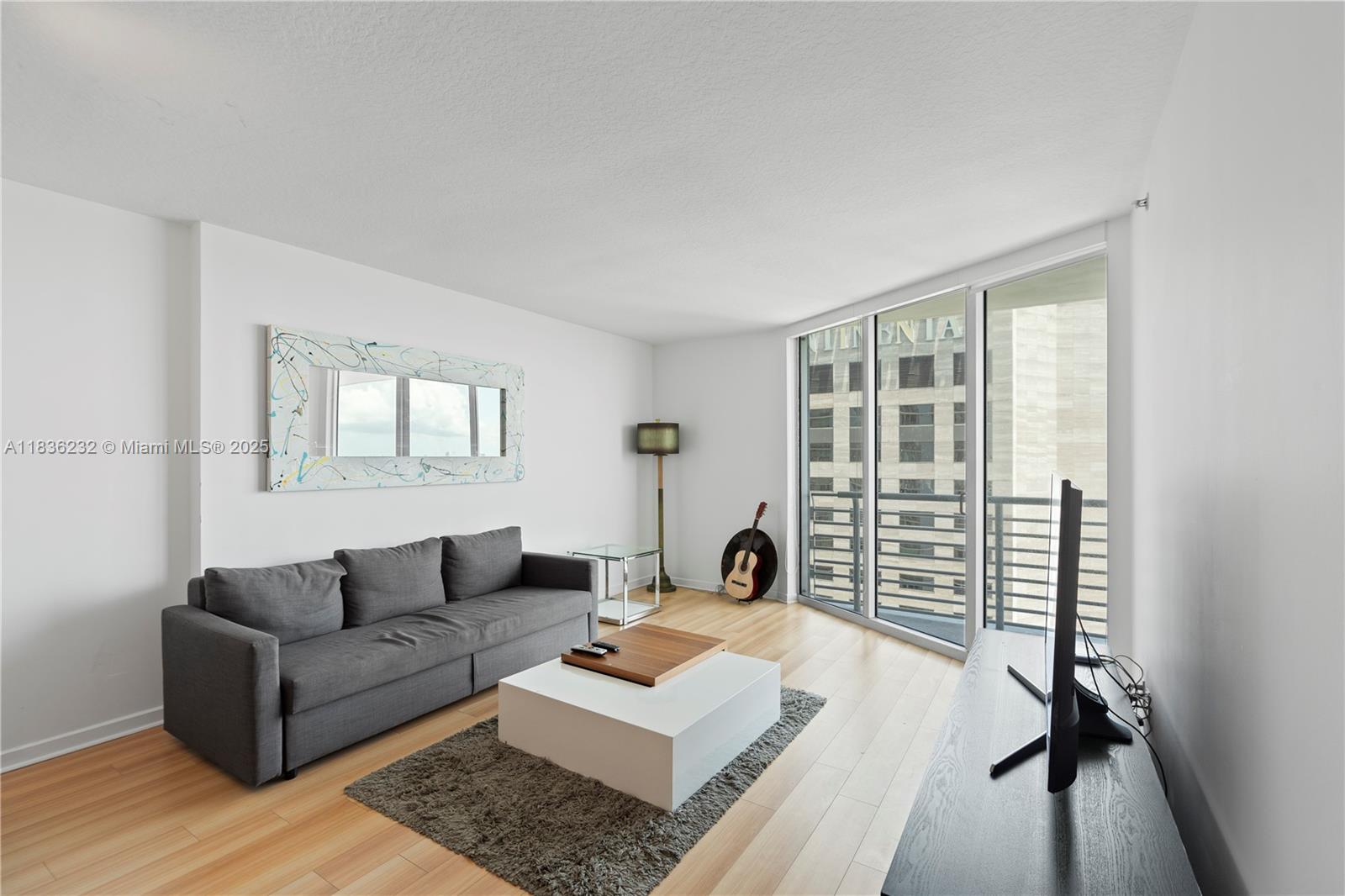 335 South Biscayne Boulevard, Unit 3410 Miami, FL 33131 - Photo 19 of 51 a living room with furniture and a window