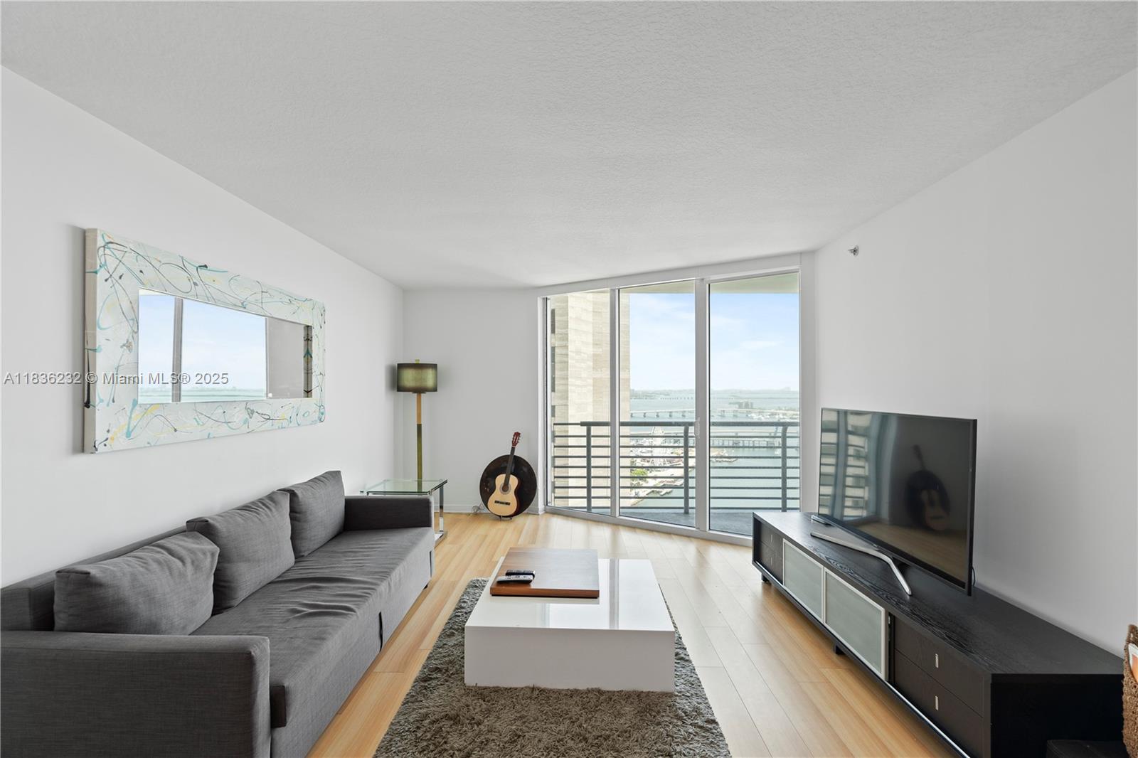335 South Biscayne Boulevard, Unit 3410 Miami, FL 33131 - Photo 20 of 51 a living room with furniture and a flat screen tv