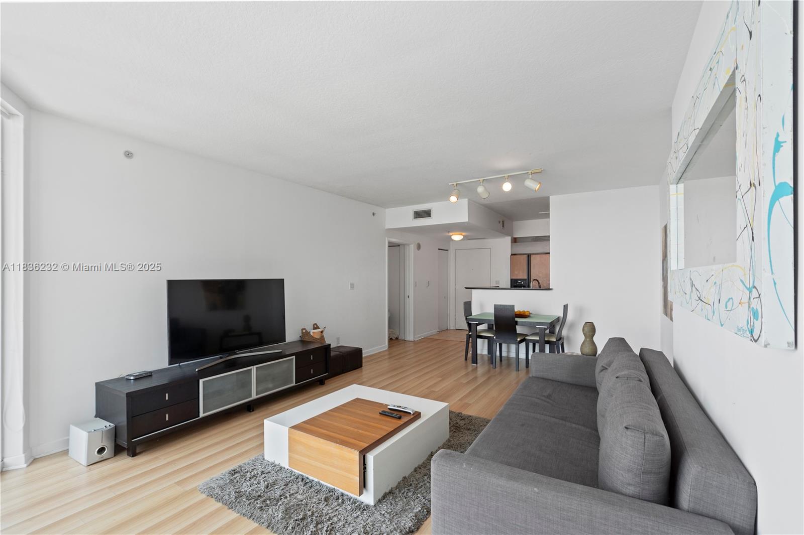 335 South Biscayne Boulevard, Unit 3410 Miami, FL 33131 - Photo 21 of 51 a living room with furniture and a flat screen tv