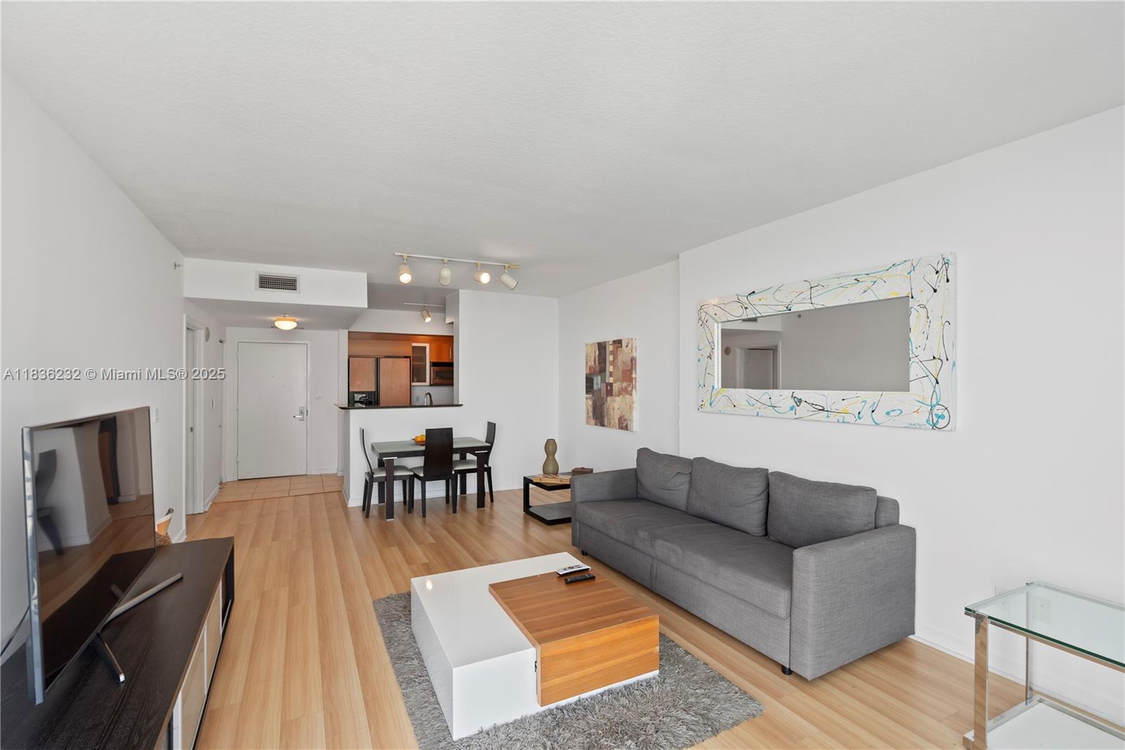 335 South Biscayne Boulevard, Unit 3410 Miami, FL 33131 - Photo 22 of 51 a living room with furniture and a flat screen tv