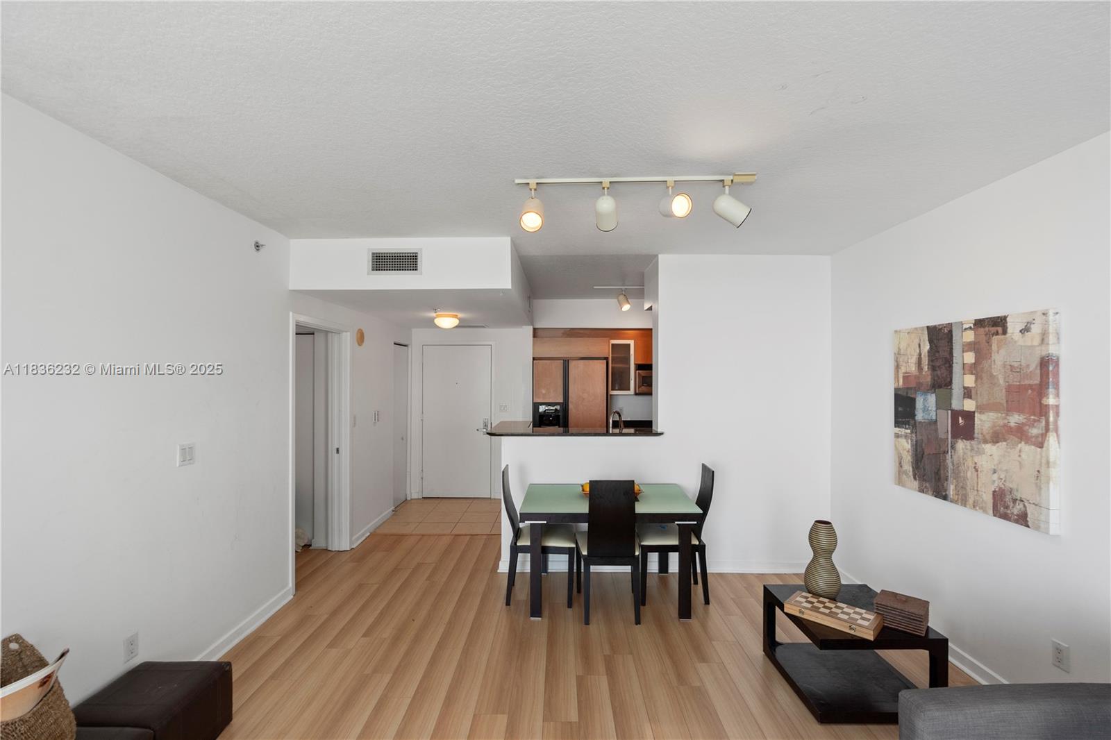 335 South Biscayne Boulevard, Unit 3410 Miami, FL 33131 - Photo 24 of 51 a view of a dining room with furniture and wooden floor