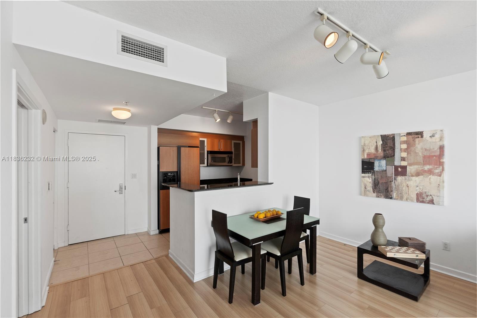 335 South Biscayne Boulevard, Unit 3410 Miami, FL 33131 - Photo 25 of 51 a view of a dining room with furniture and wooden floor