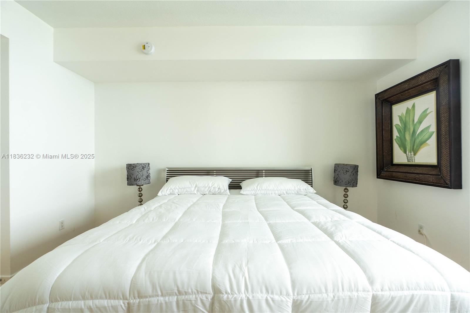 335 South Biscayne Boulevard, Unit 3410 Miami, FL 33131 - Photo 26 of 51 a bedroom with a bed and a window