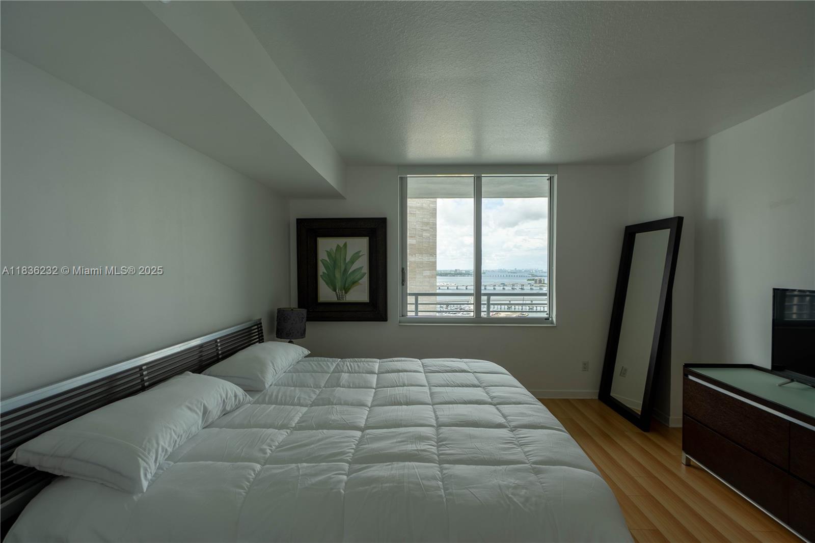 335 South Biscayne Boulevard, Unit 3410 Miami, FL 33131 - Photo 28 of 51 a bedroom with a bed and a large window