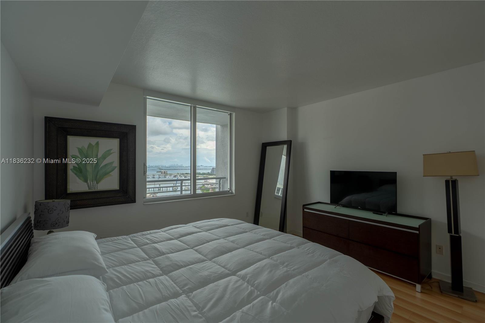 335 South Biscayne Boulevard, Unit 3410 Miami, FL 33131 - Photo 29 of 51 a bedroom with a bed and a television