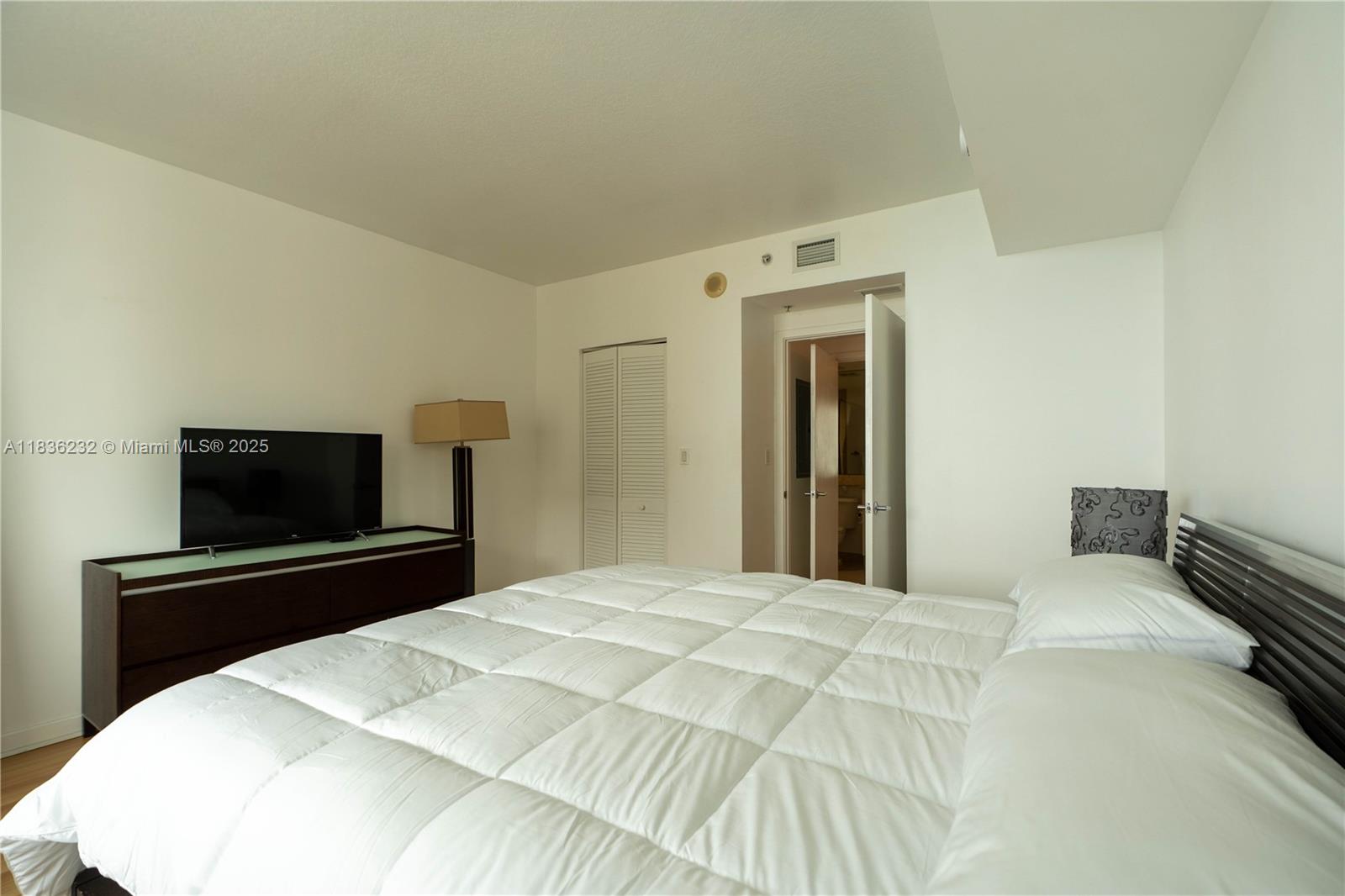 335 South Biscayne Boulevard, Unit 3410 Miami, FL 33131 - Photo 30 of 51 a bedroom with a bed and a flat screen tv