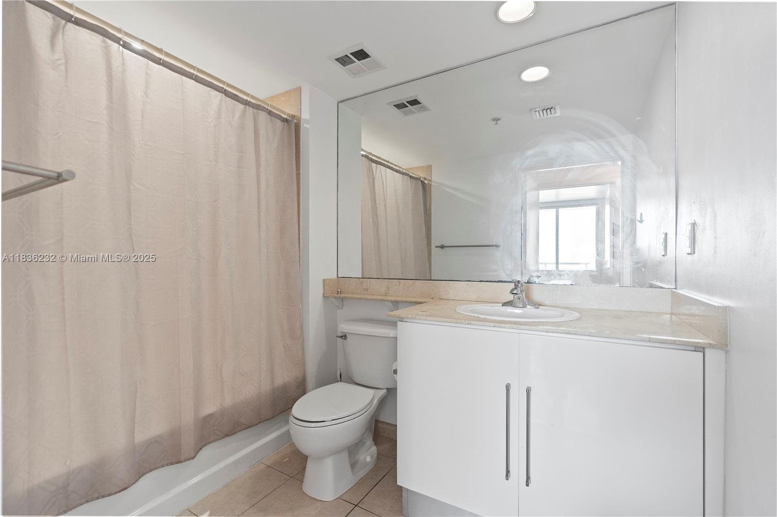 335 South Biscayne Boulevard, Unit 3410 Miami, FL 33131 - Photo 34 of 51 a bathroom with a granite countertop sink a toilet and a mirror