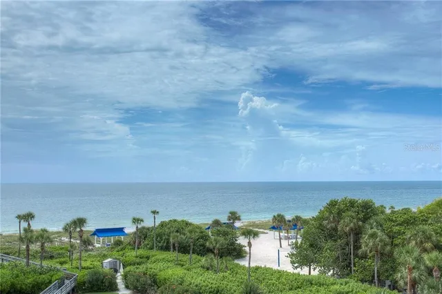 a view of a lake with houses in back