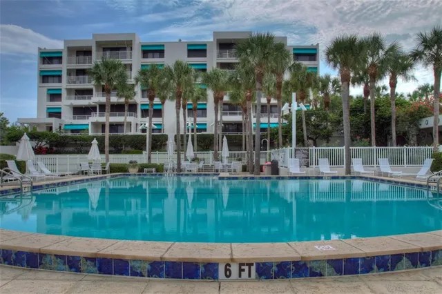 a swimming pool is sitting in front of a brick building