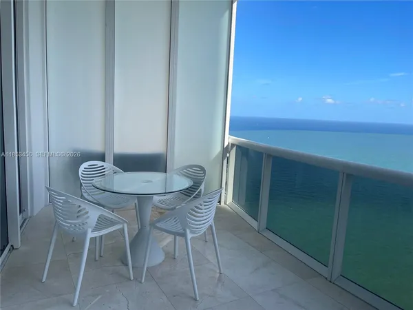a backyard with table and chairs