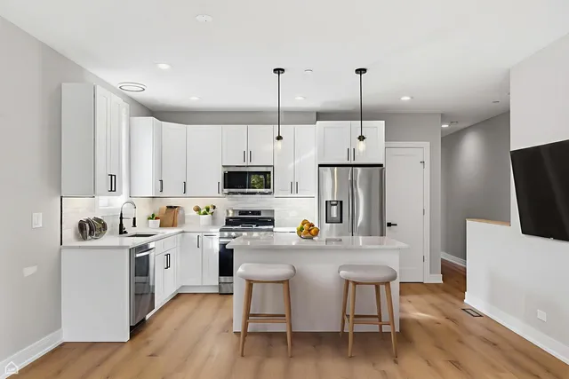 a view of a balcony with wooden floor and outdoor seating