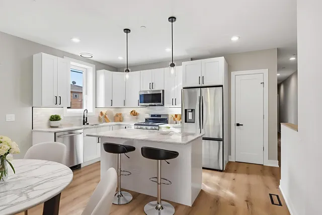 a view of walk in closet with wooden floor