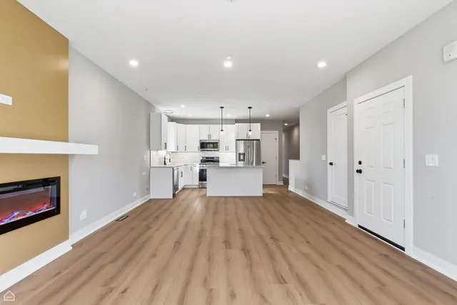 a view of a room with wooden floor and window