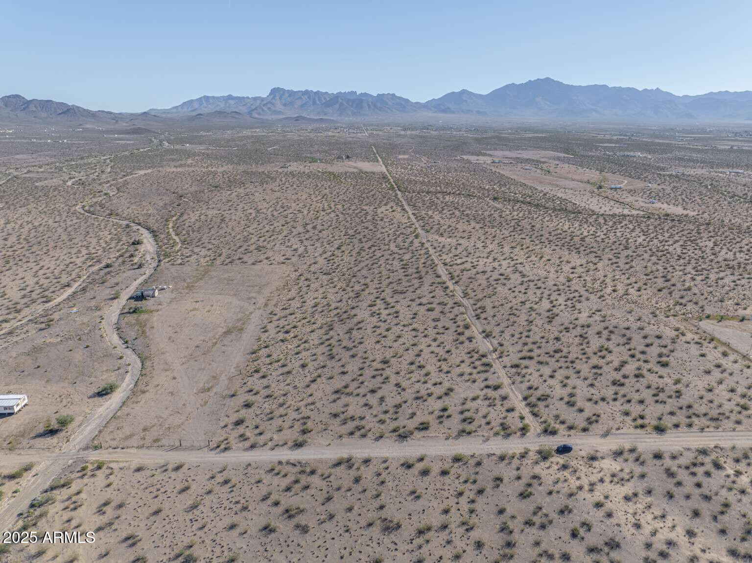 0 North Bullhead Road, Unit 57 Dolan Springs, AZ 86441 - Photo 8 of 36 a view of a dry yard with mountains in the background