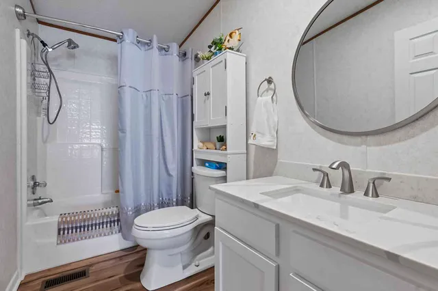 a bathroom with a sink toilet and shower