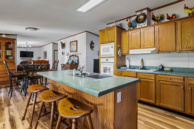 a kitchen with stainless steel appliances granite countertop a sink and cabinets