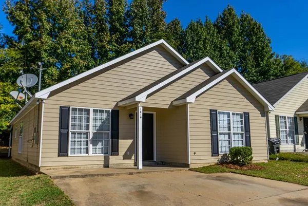 a view of front of house with a yard