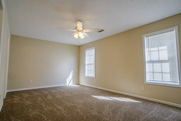 a view of empty room with windows