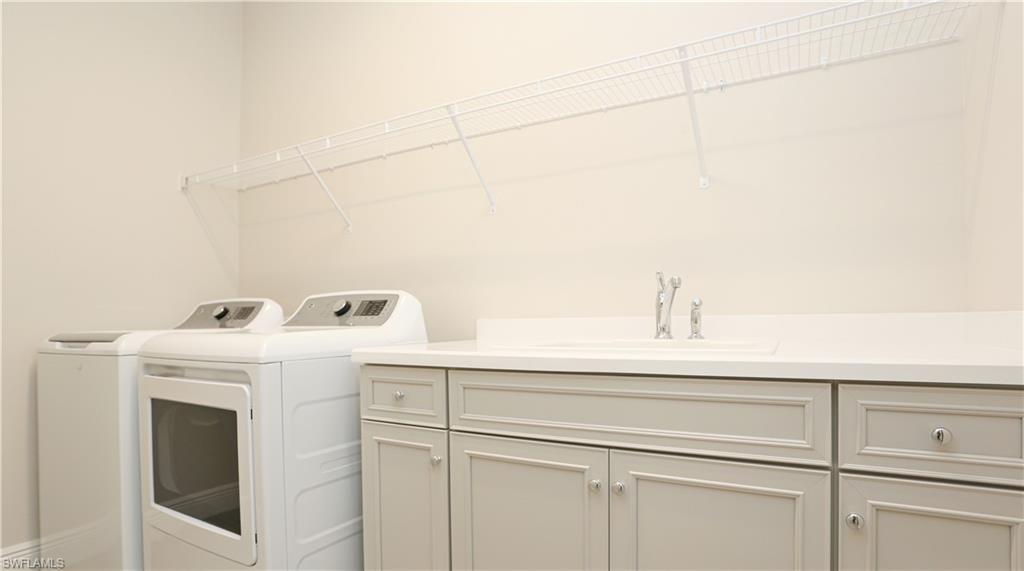 2428 Ariane Drive Naples, FL 34112 - Photo 13 of 23 a utility room with dryer and washer