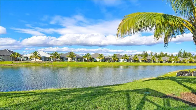 a view of a lake with a houses in the background