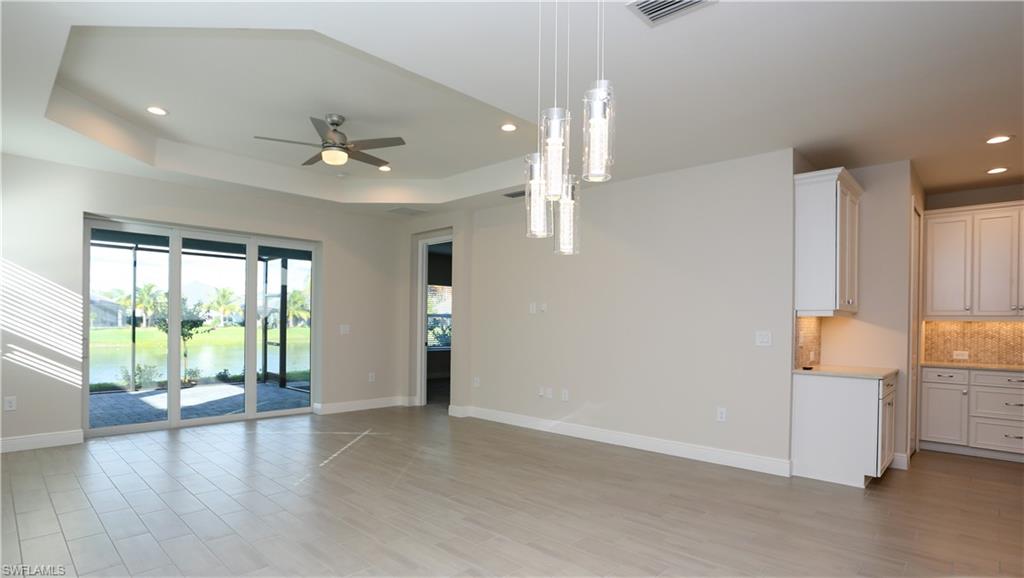 2428 Ariane Drive Naples, FL 34112 - Photo 5 of 23 wooden floor in an empty room with a window