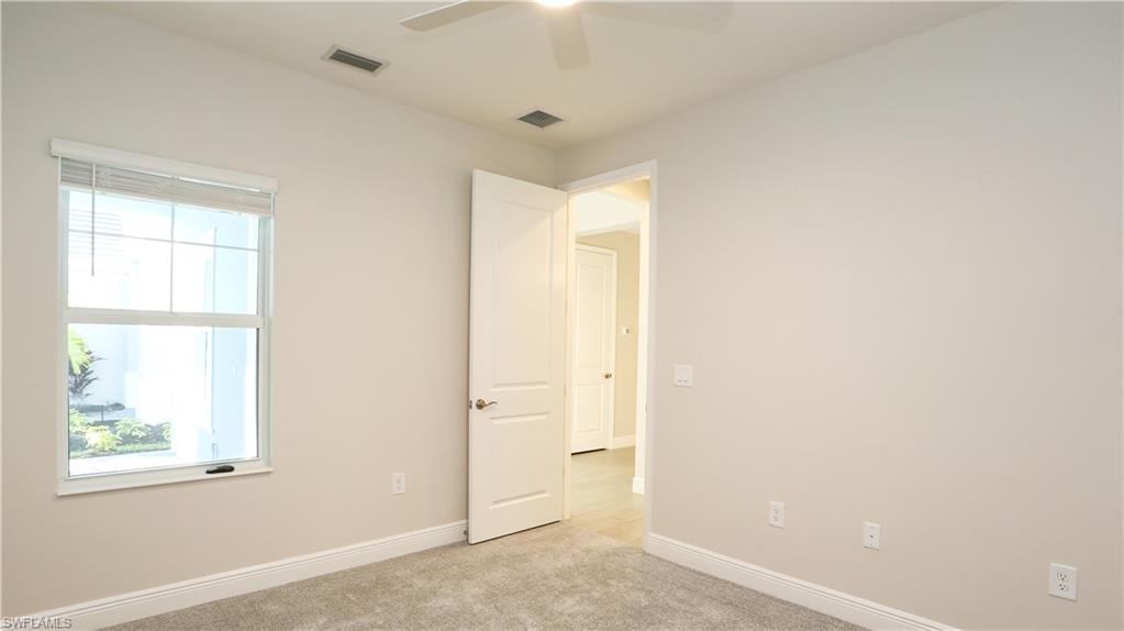 2428 Ariane Drive Naples, FL 34112 - Photo 9 of 23 an empty room with a window