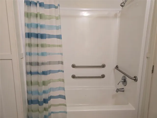 a bathroom with a bathtub and shower