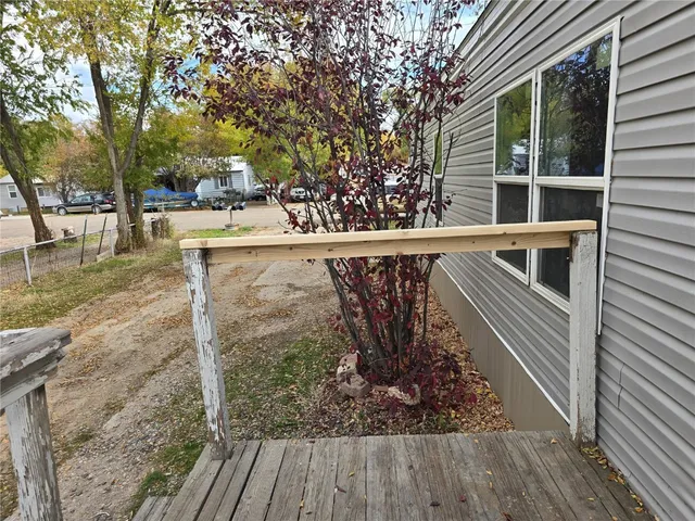 a view of balcony with wooden floor and fence