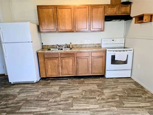 a kitchen with cabinets appliances and a counter space