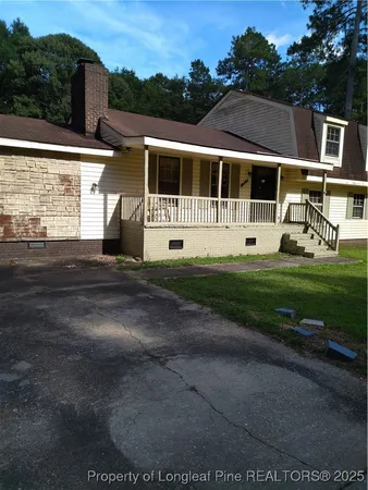 a view of house with yard and entertaining space