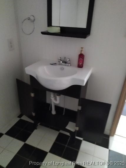 12121 Cameron Way Maxton, NC 28364 - Photo 19 of 29 a bathroom with a sink and a mirror