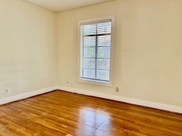 2511 Enfield Road, Unit B Austin, TX 78703 - Photo 12 of 12 an empty room with wooden floor and windows