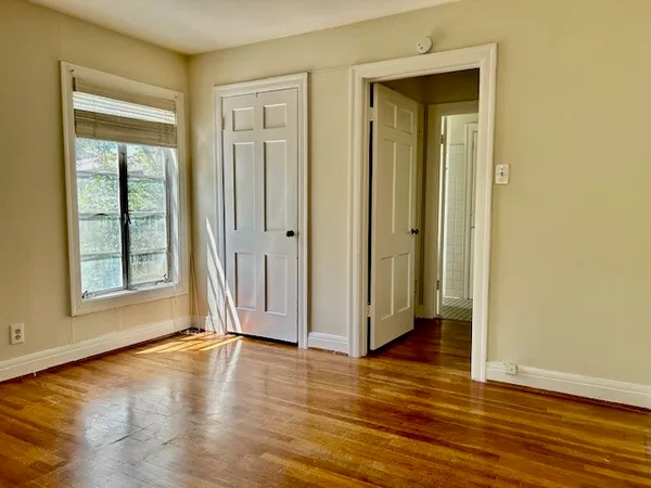 a view of a livingroom with wooden floor and window