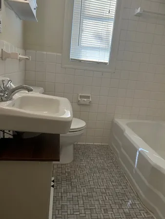 a bathroom with a sink a toilet and bathtub
