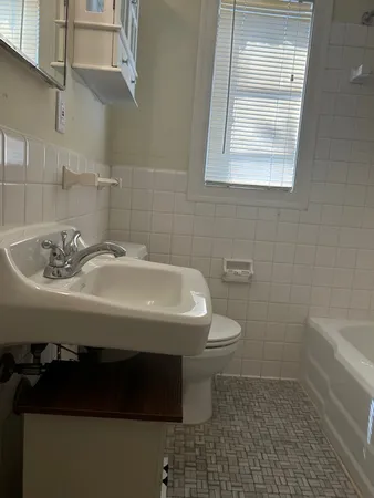 a bathroom with a sink a toilet and bathtub