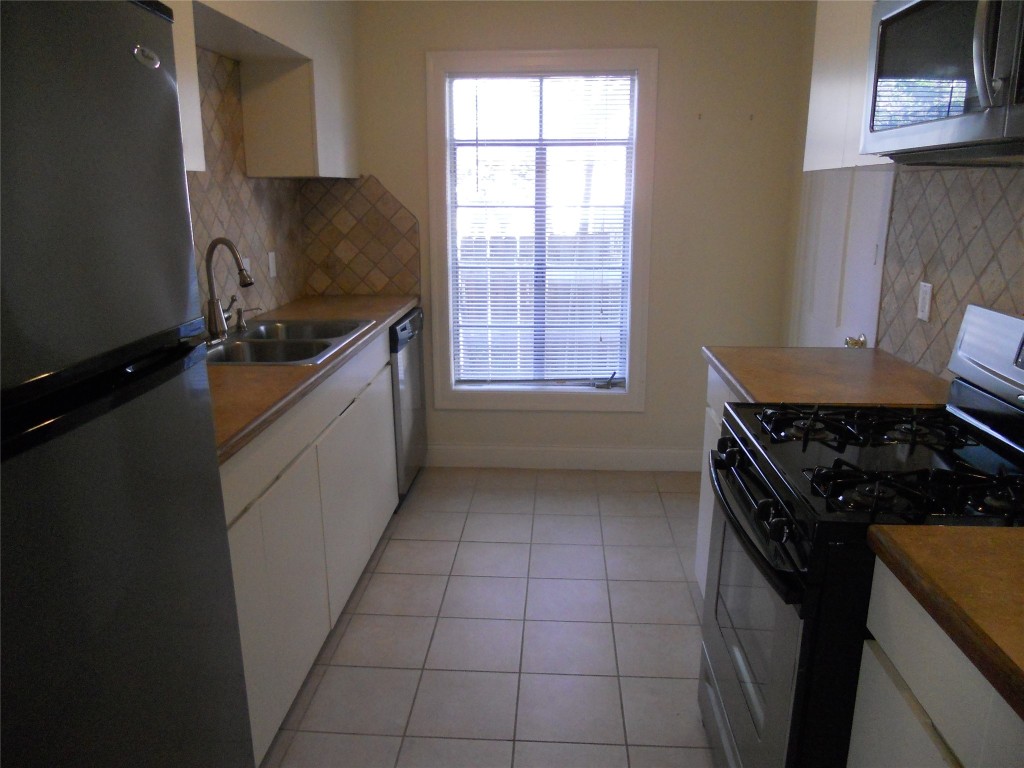 2511 Enfield Road, Unit B Austin, TX 78703 - Photo 5 of 12 a kitchen with a sink a stove and cabinets