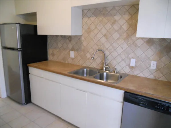 a kitchen with a sink and a refrigerator