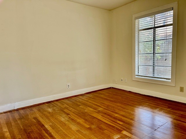 2511 Enfield Road, Unit B Austin, TX 78703 - Photo 9 of 12 an empty room with wooden floor and windows