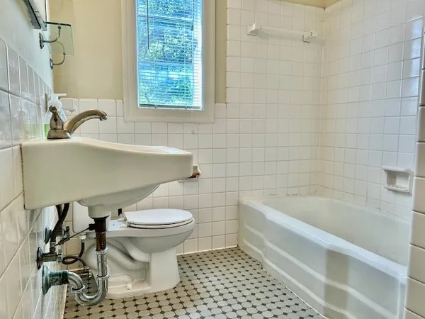 a bathroom with a sink a toilet and bathtub