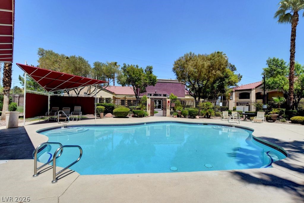 7885 West Flamingo Road, Unit 1079 Las Vegas, NV 89147 - Photo 29 of 35 This inviting community pool offers a refreshing oasis under a clear sky.