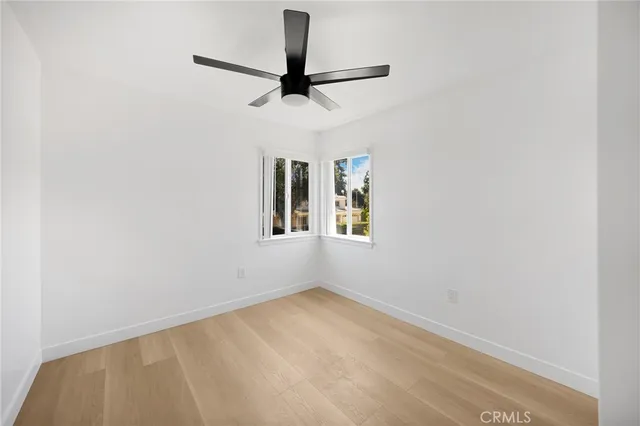 a view of empty room with ceiling fan
