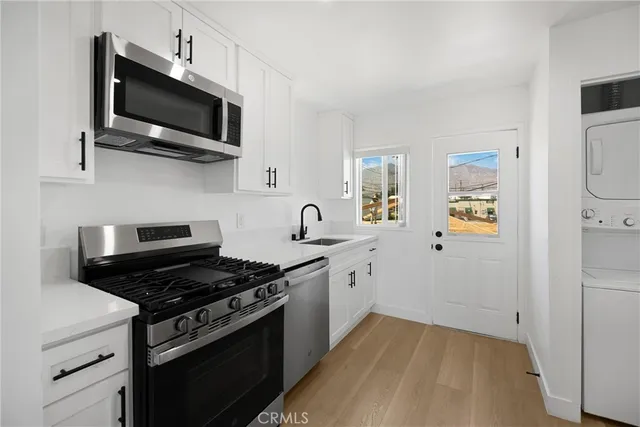 a kitchen with stainless steel appliances a stove a microwave and cabinets