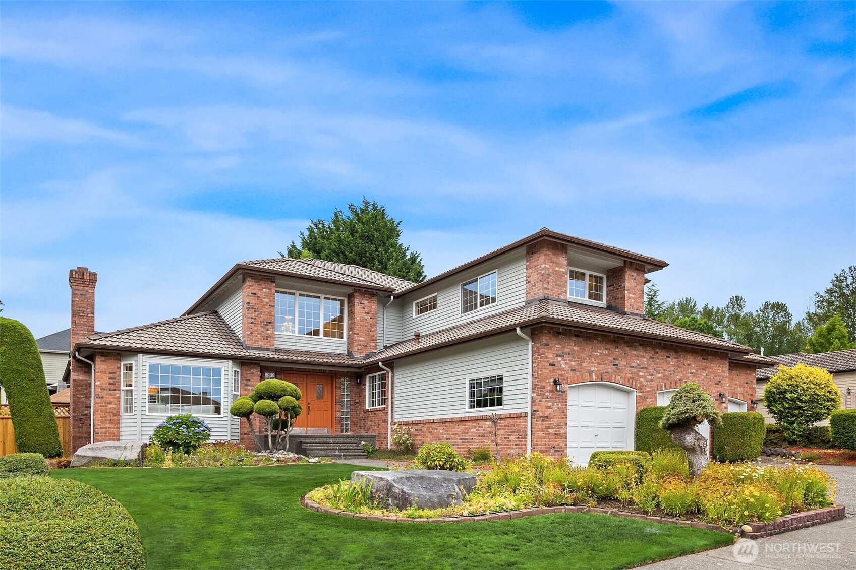 a front view of a house with garden
