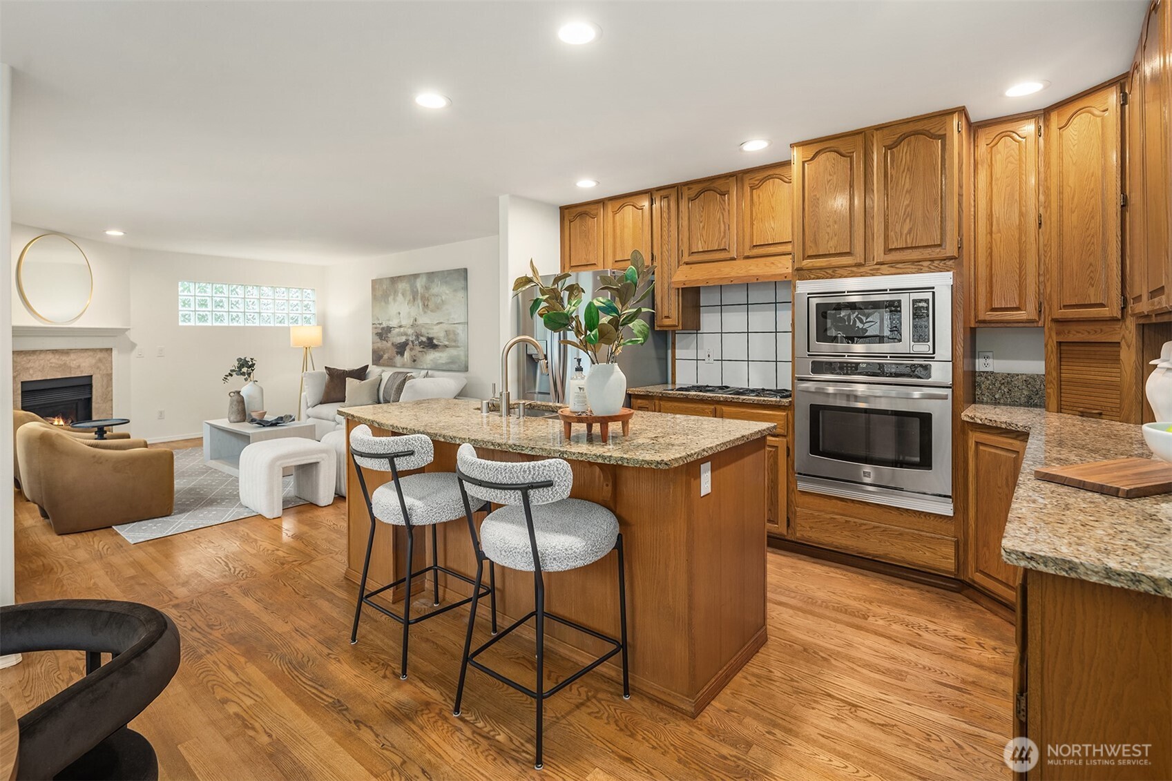 1417 232nd Place Southwest Bothell, WA 98021 - Photo 12 of 40 a kitchen with stainless steel appliances granite countertop a stove a sink a microwave a dining table and chairs