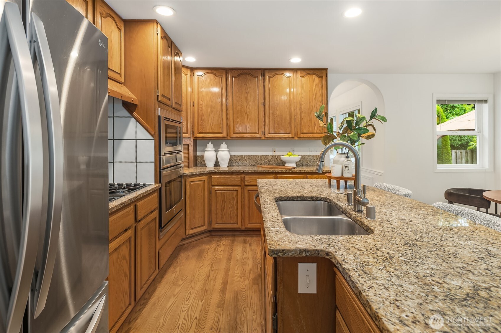 1417 232nd Place Southwest Bothell, WA 98021 - Photo 14 of 40 a kitchen with a sink a counter top space cabinets and stainless steel appliances